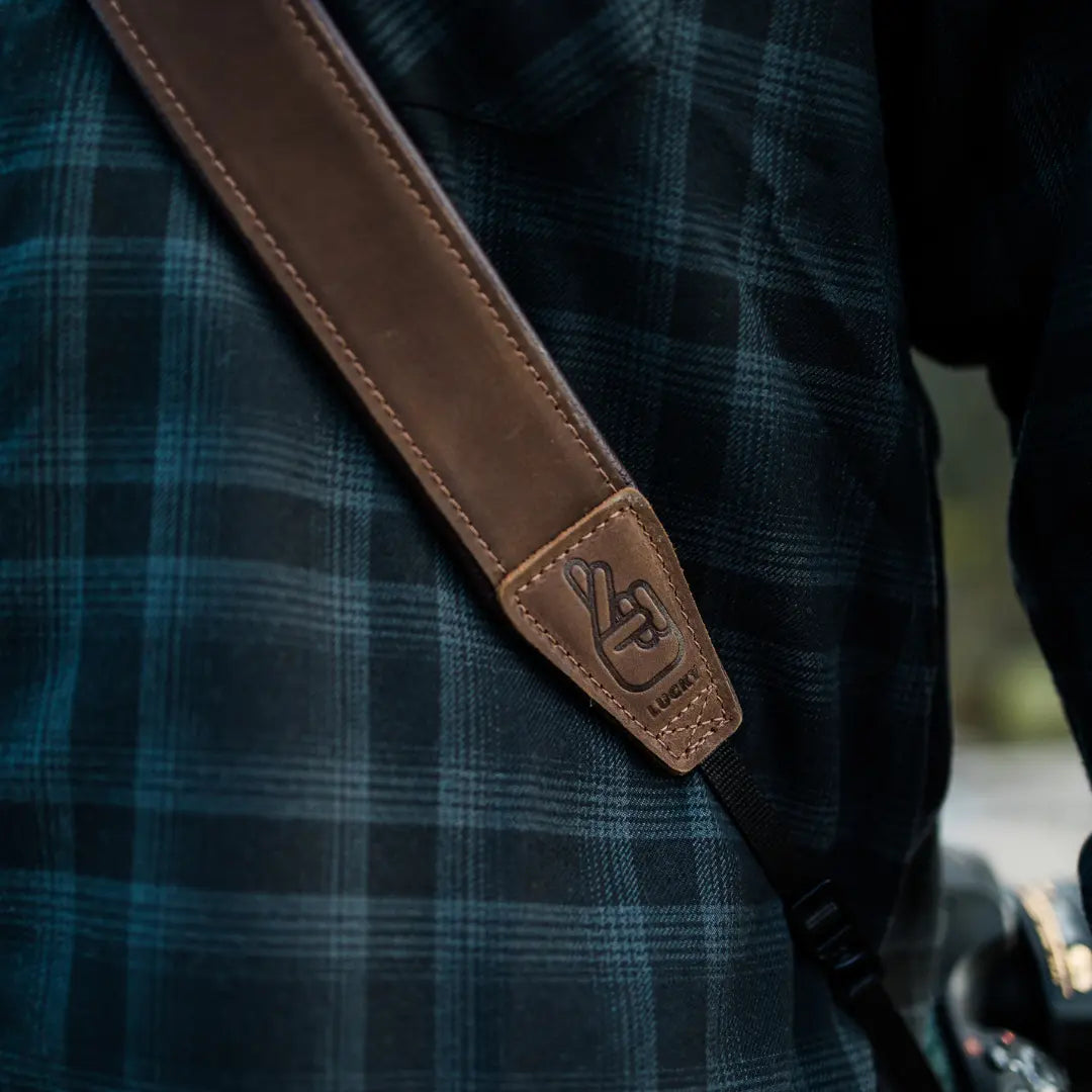 Close up of brown leather camera strap with soft padding
