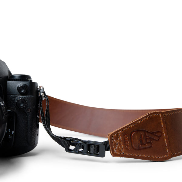 Close up of Lucky Straps quick release system on leather camera strap