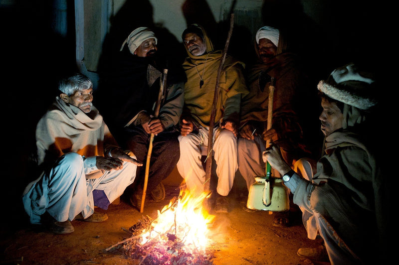 Men gather around a fire as they guard a Christian village against the possibility of attacks by Islamic fundamentalists. Pujab, Pakistan.