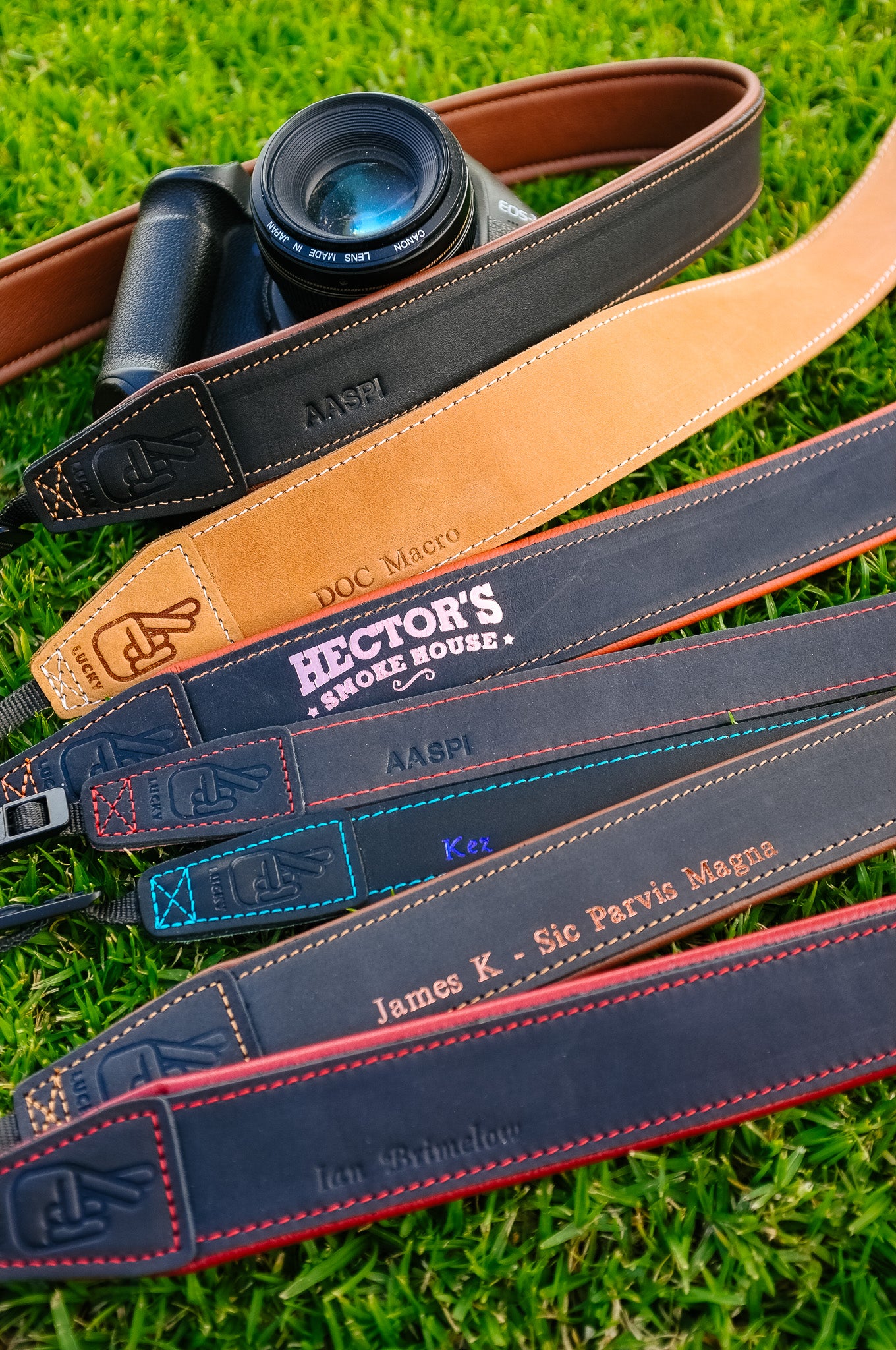 Range of leather camera straps all with different custom logos and personalisation