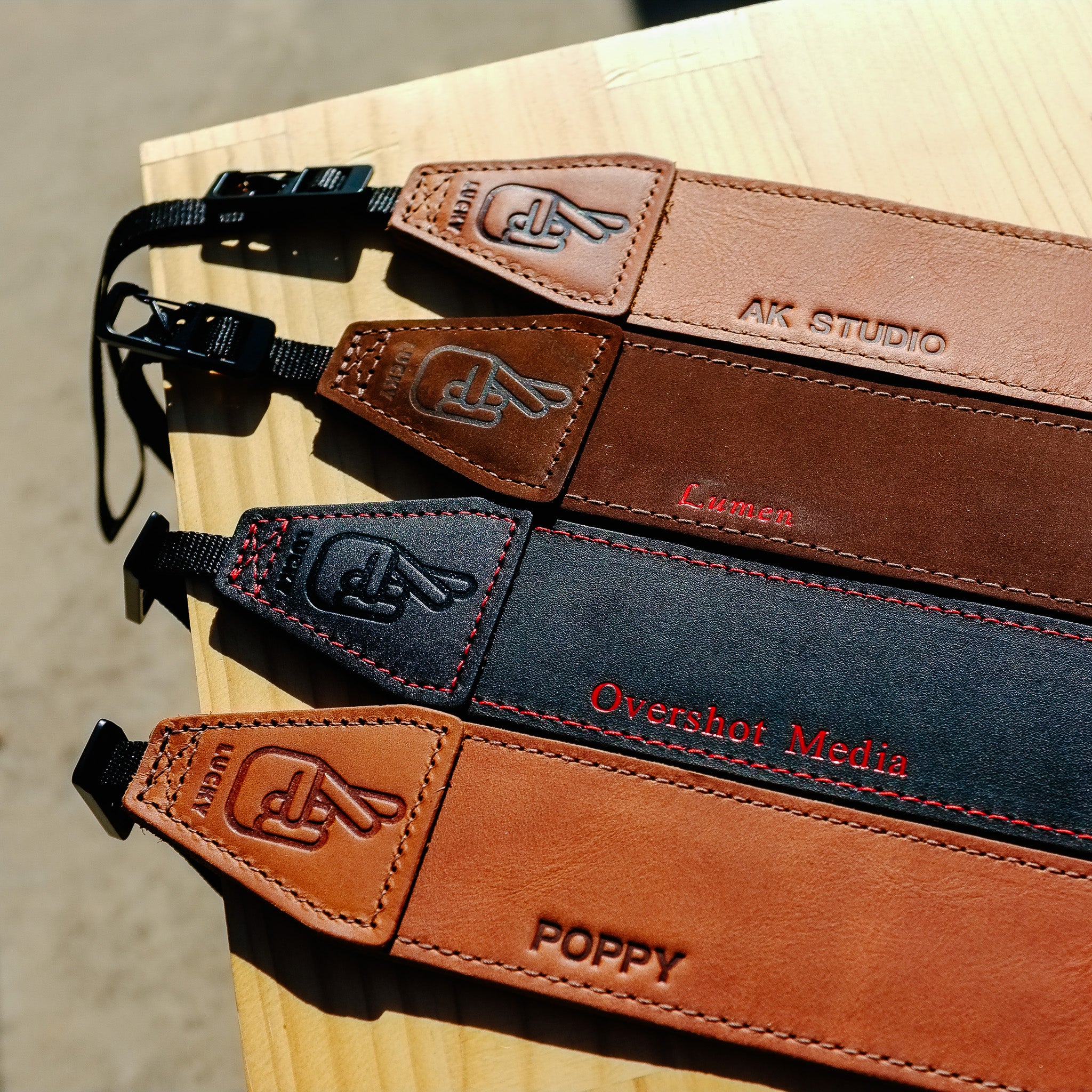 Four leather camera straps with personalisation
