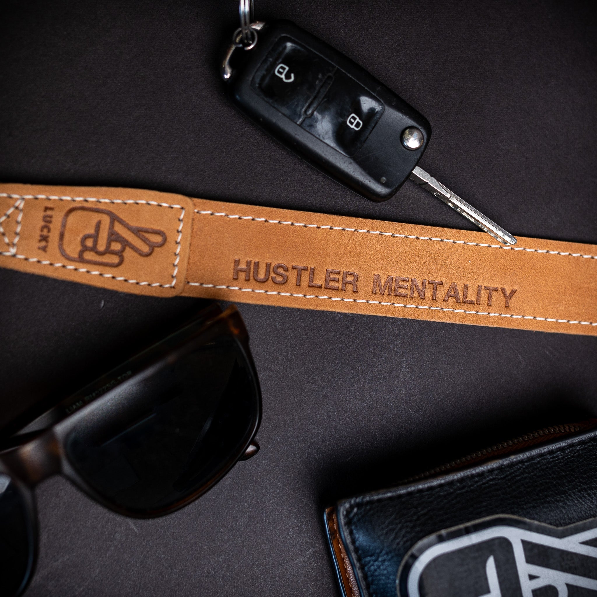 Flat lay of leather camera strap with personalised photography business