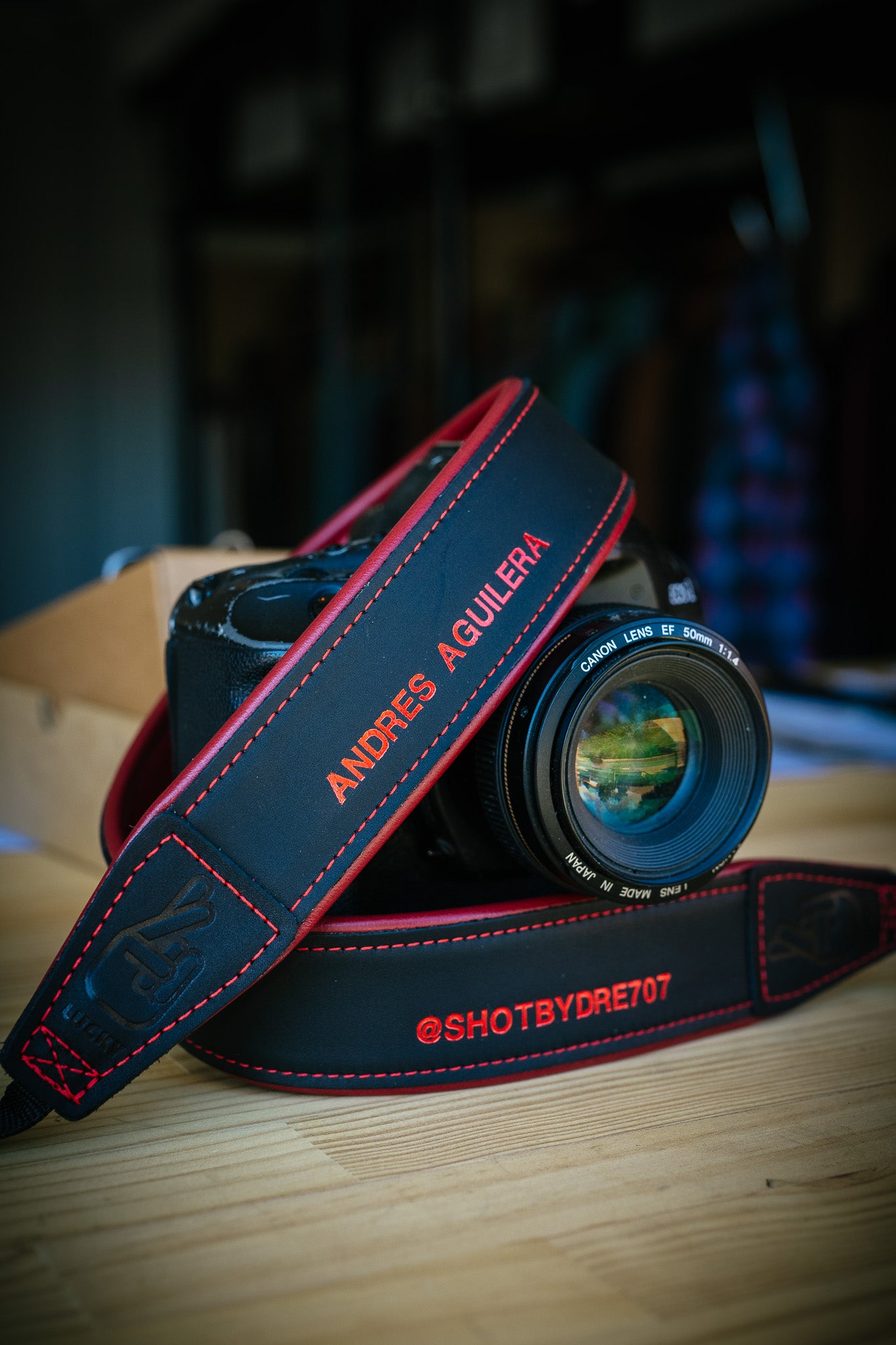 Personalised leather camera strap in black and red leather