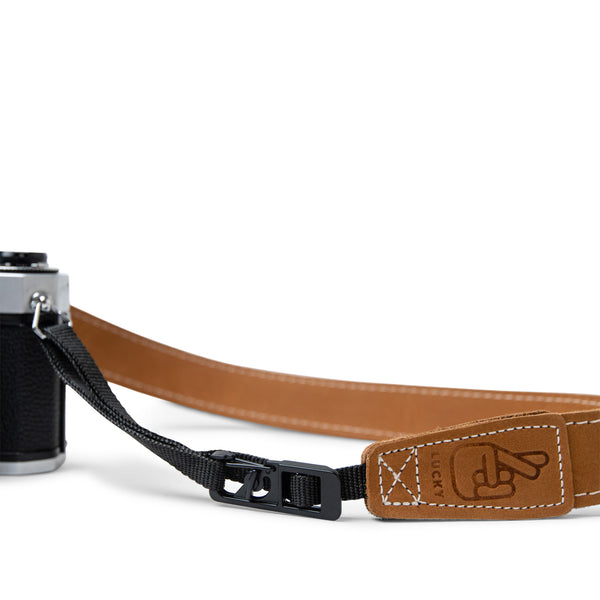 Close up of Lucky Straps quick release system on leather camera strap